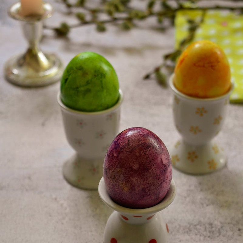 photo of some colored eggs in stands